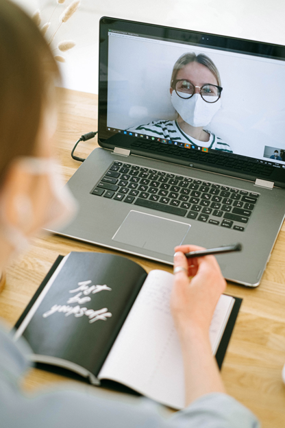 computer with masked girl on zoom